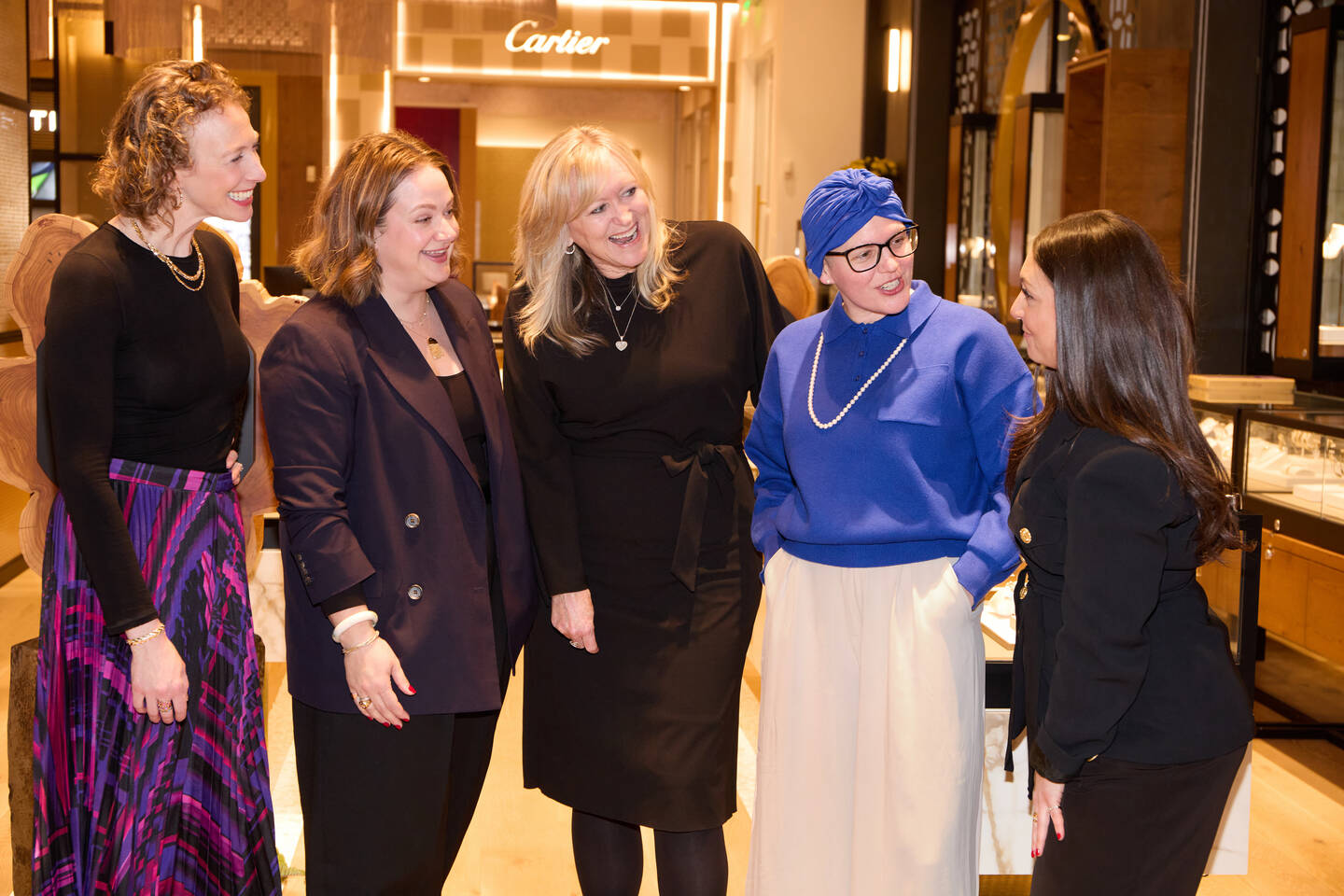 Five women smiling inside of a Ben Bridge jewelry store in downtown Seattle